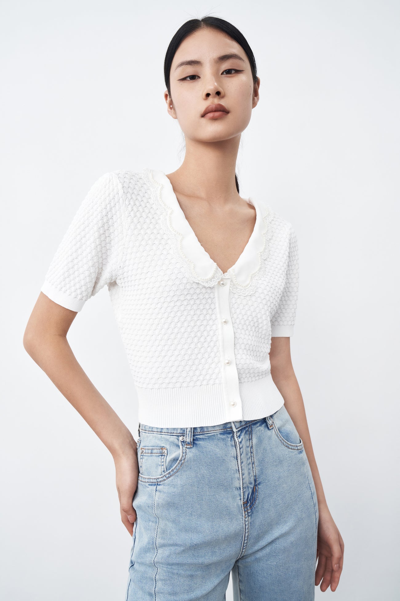 Knitted white women short-sleeved top with button