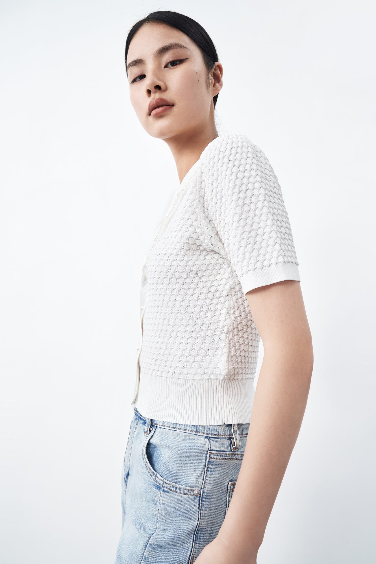 Knitted white women short-sleeved top with button